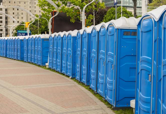 a row of portable restrooms set up for a large athletic event, allowing participants and spectators to easily take care of their needs in Brookline