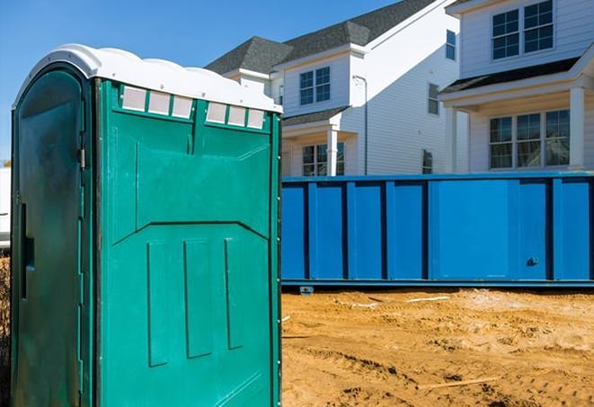 workers at a construction site take advantage of convenient portable toilets